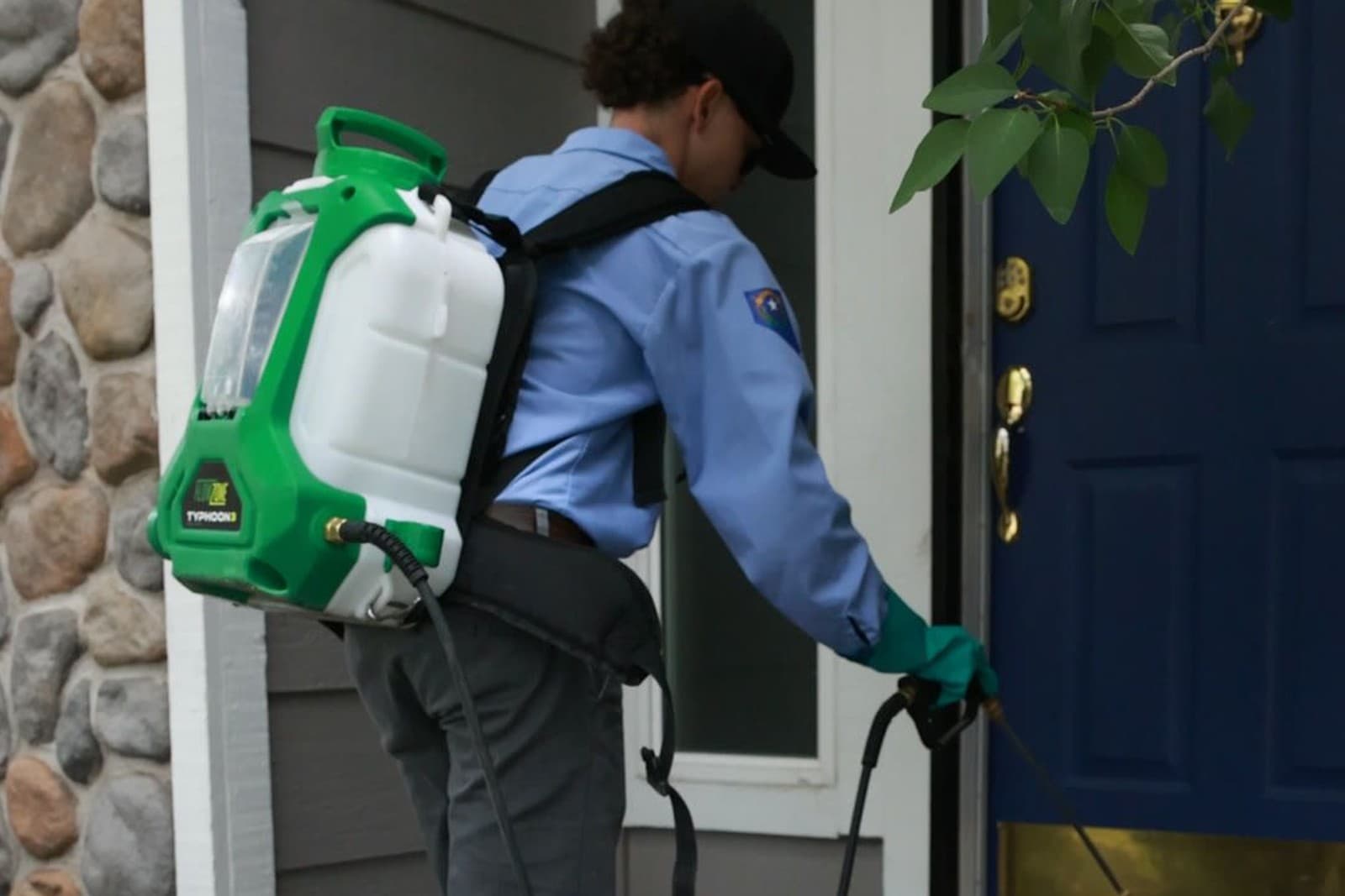 A Butter Pest Control technician treating the entry of a home