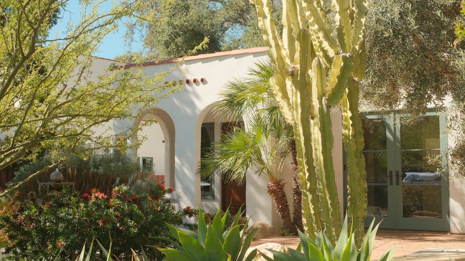 Spanish-style home with cactus and desert landscaping