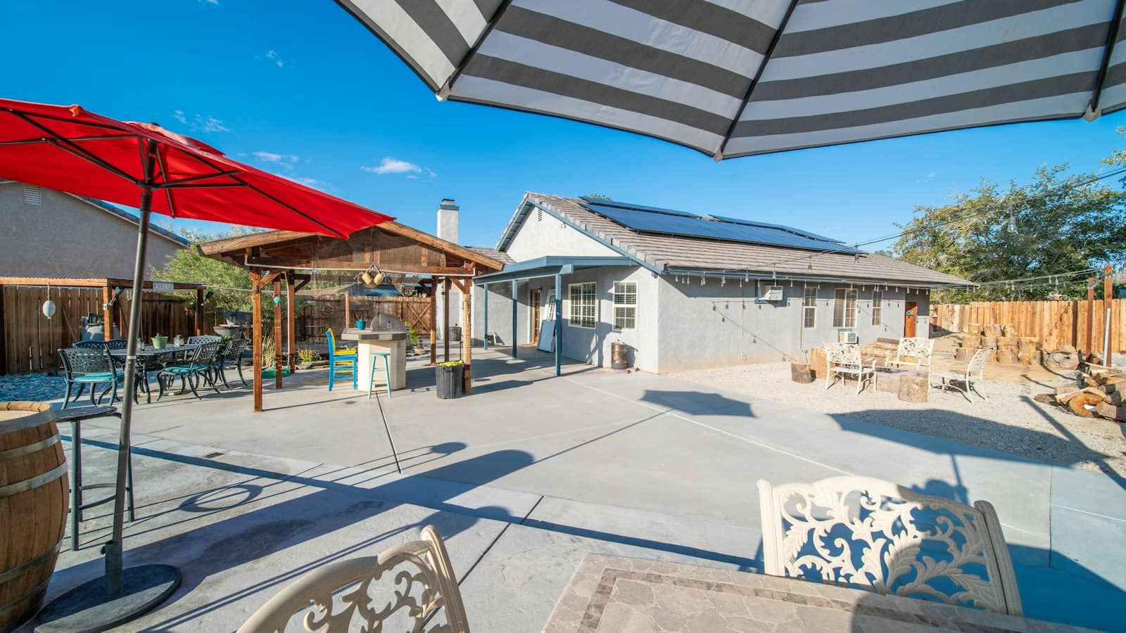 Backyard patio with shade umbrellas on a hot summer day