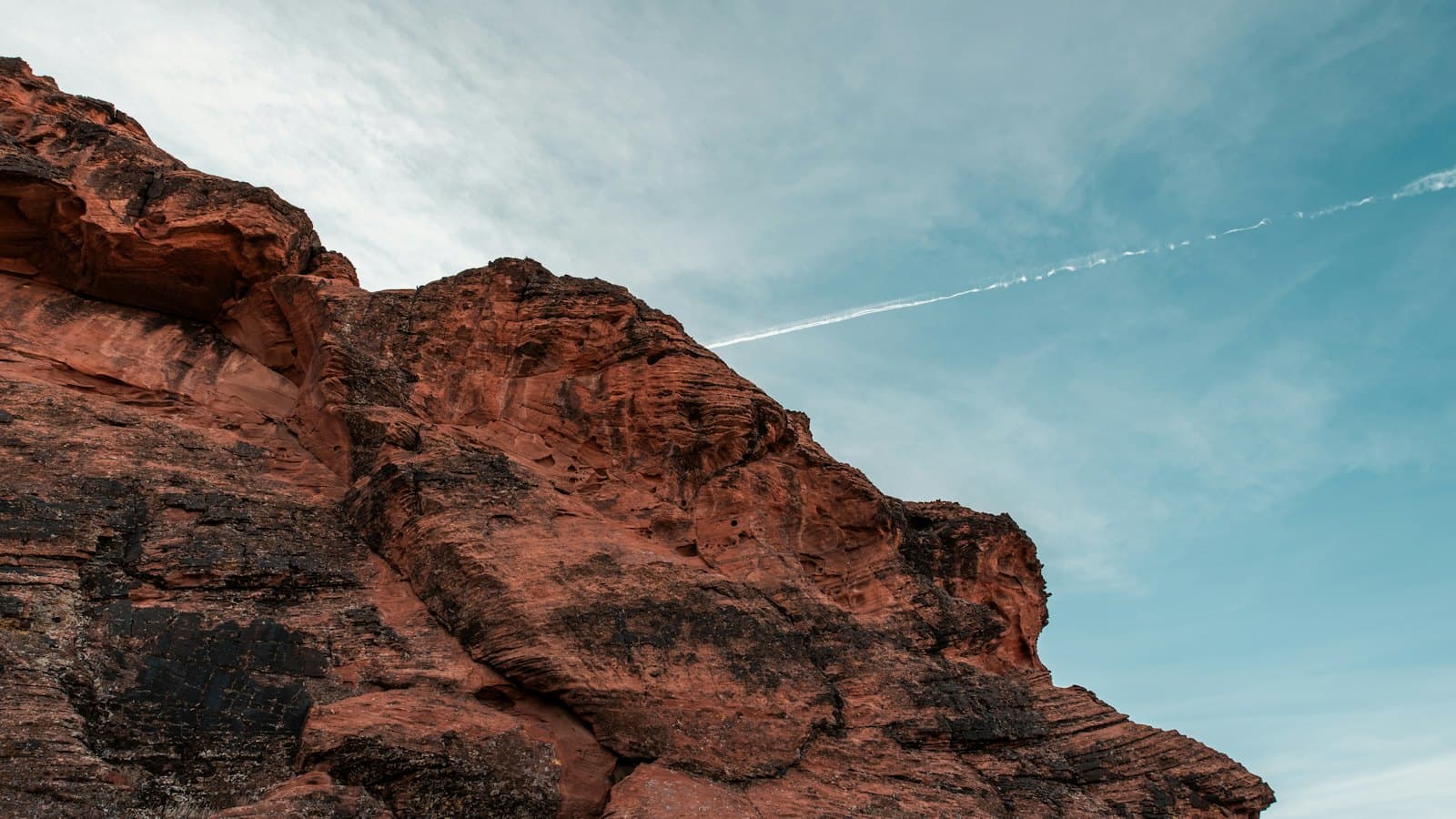 Red rock cliff under a hot blue sky in Snow Canyon State Park near St. George