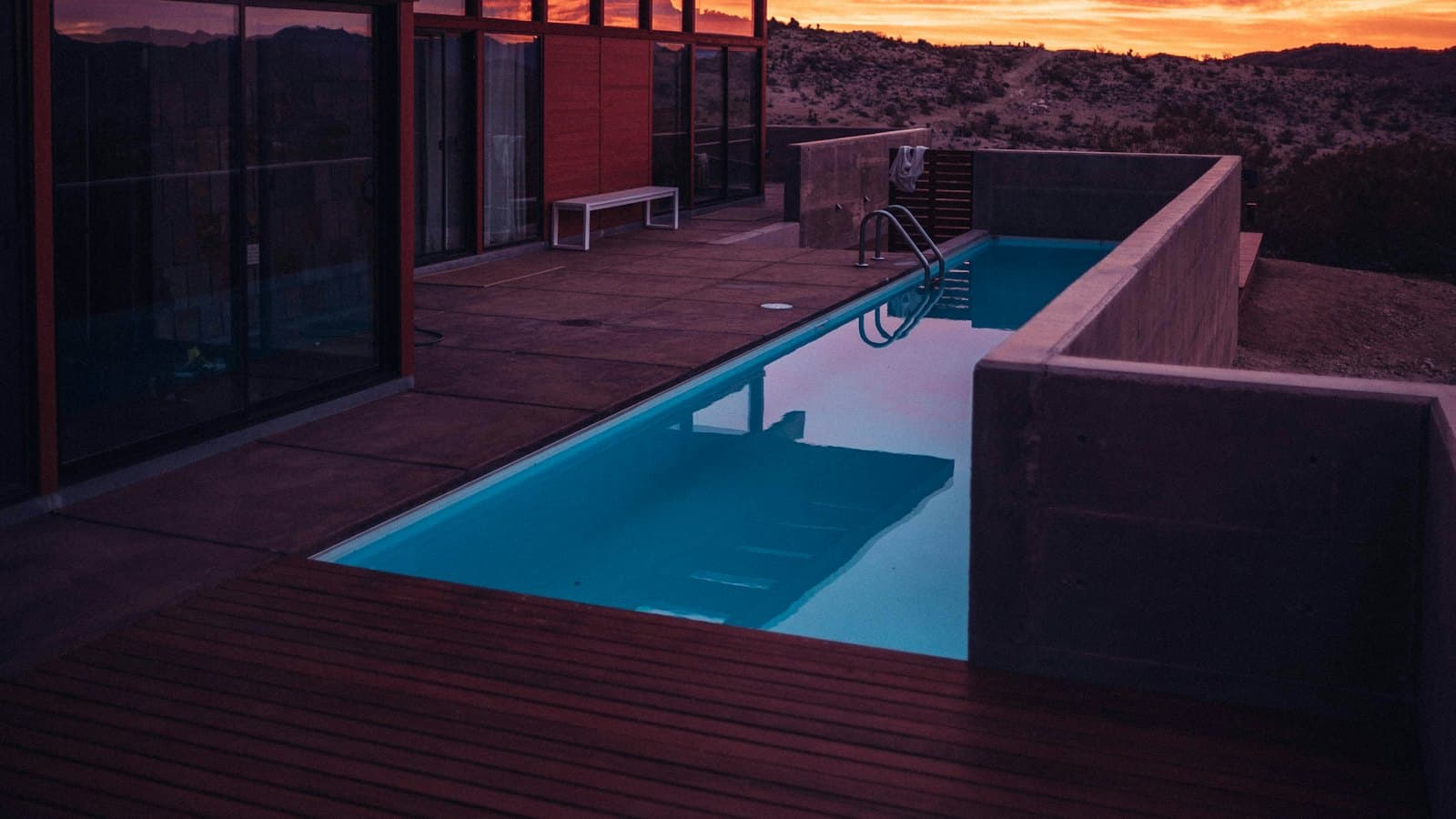Modern home with a pool at sunset