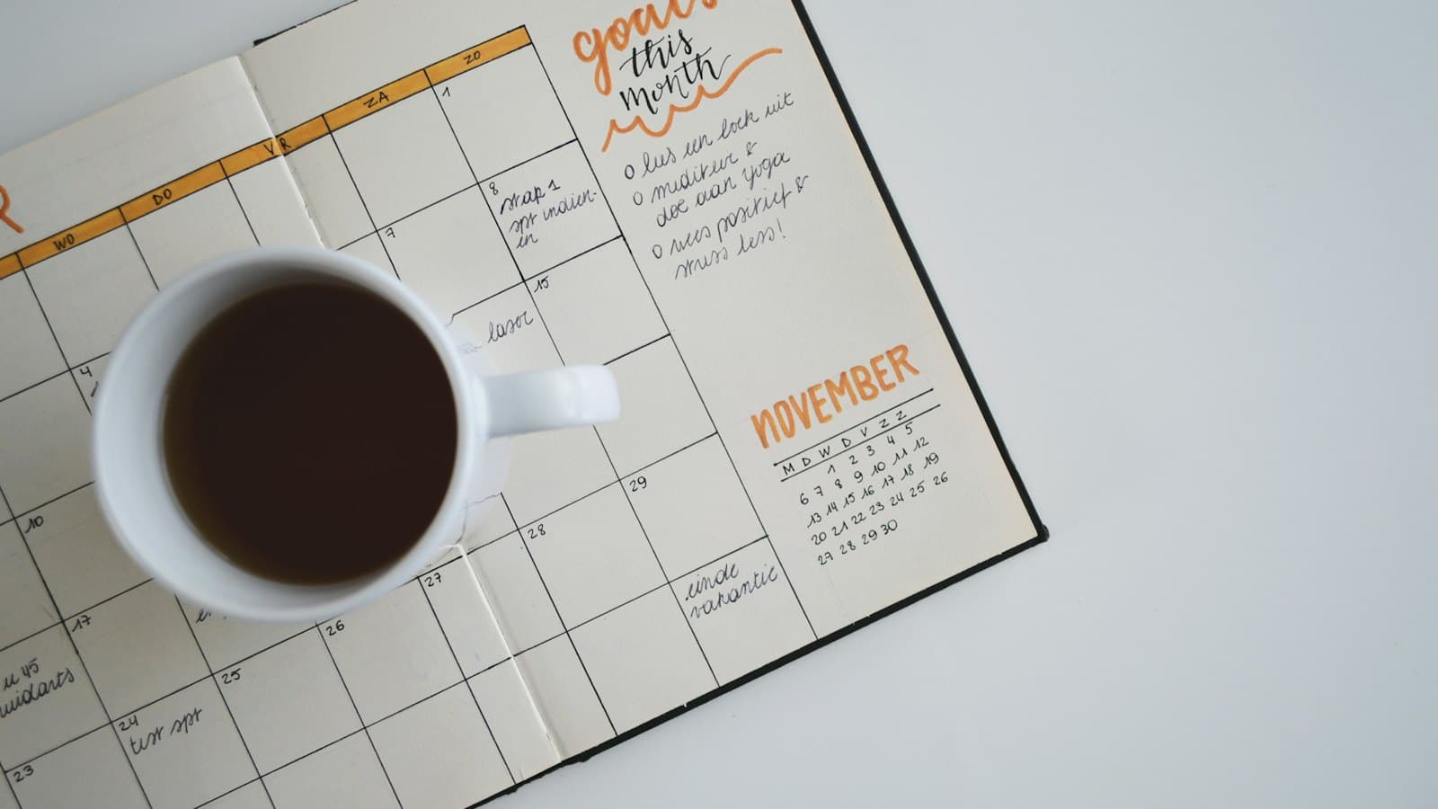 Monthly planner and a cup of coffee