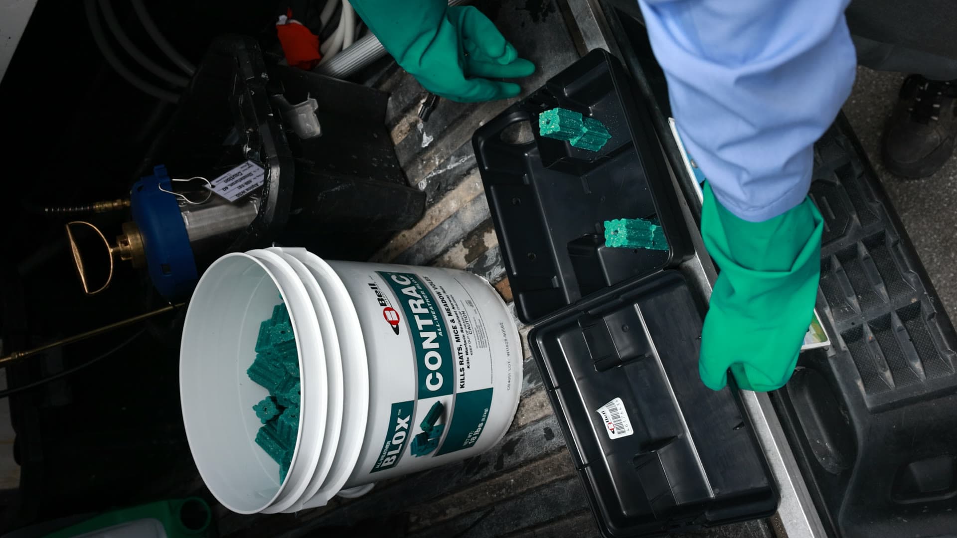 Butter Pest Control technician preparing rodent bait stations for a commercial property